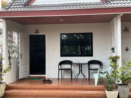 A room's porch at Baan Kan: two chairs and a small table