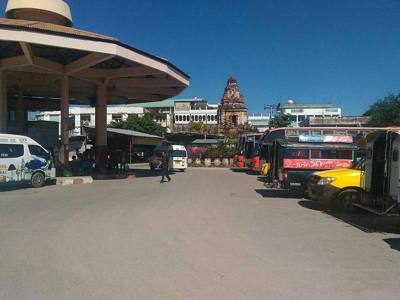 Station building Chang Phuak Bus station in Chiang Mai, with a view to an old Chedi of a former temple (Wat Pan Sat).