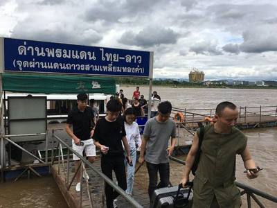 People disembarking from the boat from the Golden Triangle Special Economic Zone in Laos to enter Thailand at the Chiang Saen Immigration Thailand-Laos…