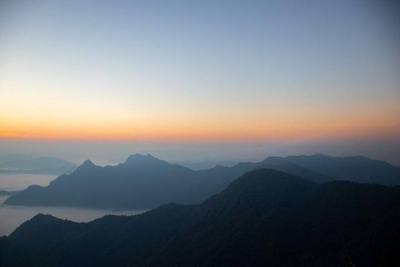 An early morning landscape capturing the peaceful horizon and endless waves of fog at Phu Chi Fa.