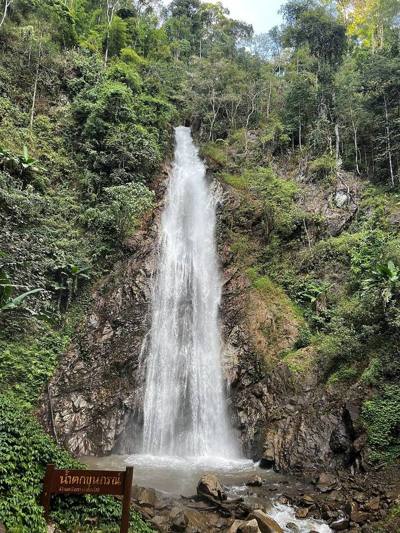 Khunkorn Waterfall and a sign in Lam Nam Kok National Park, Chiang Rai, Thailand