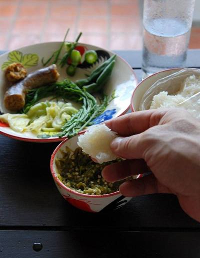 Khao niao (sticky or glutinous rice) is eaten using the right hand. Forming it in to a flattened shape makes it easier to scoop up dishes such as the nam…