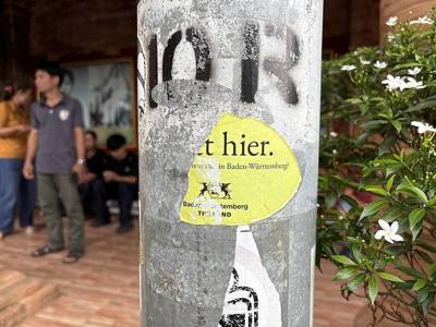 A German 'Nett Hier' sticker on a electricity pole in front of Wat Phra That Doi Suthep Temple, Chiang Mai, Thailand