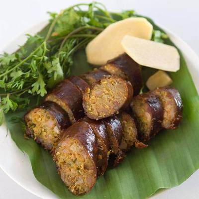 Slices of sai ua served with fresh ginger and coriander