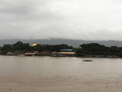 View of the Sam Liam Kham Checkpoint in the Golden Triangle Special Economic Zone, Laos, from Sop Ruak, Thailand, with the cross-border ferry headed towards…