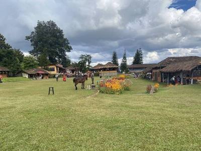 The main area of the Santichon village tourist center, it has a large grass with flowers and traditional Chinese stores surrounding it. It is located in Pai…