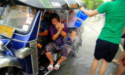 People in a tuk-tuk get targeted during the Songkran festival in Chiang Mai, Thailand
