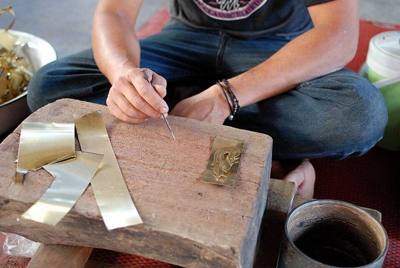Wat Phuak Taem is a centre for artisans specialised in metalwork decorations for temples in and around Chiang Mai.