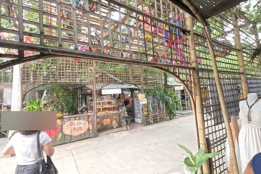 Through the lattice arch to the bakery — Chamcha Market, San Kamphaeng