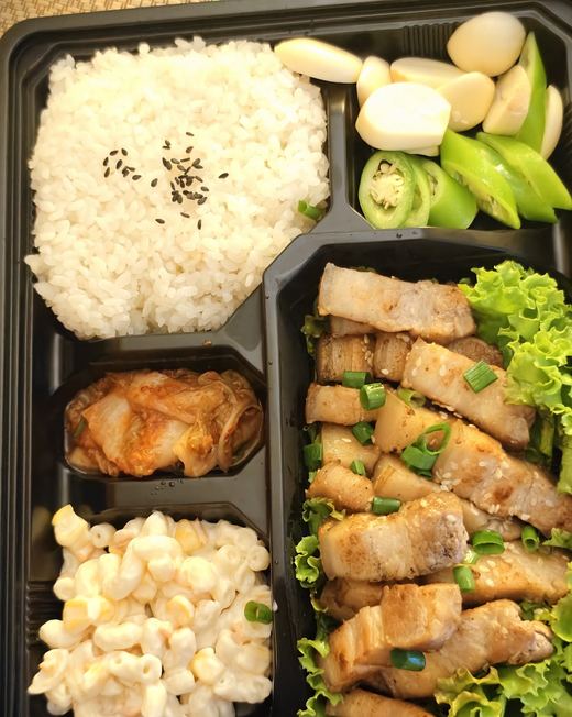 A KOBQ samgyeopsal bento: grilled pork belly, kimchi, macaroni and rice