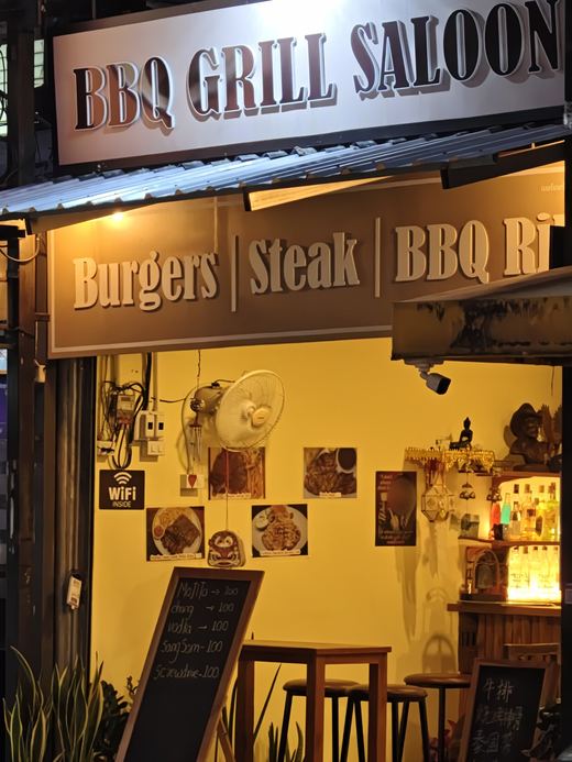 BBQ Grill Saloon's open front: chalkboard drinks, high stools, wifi sign