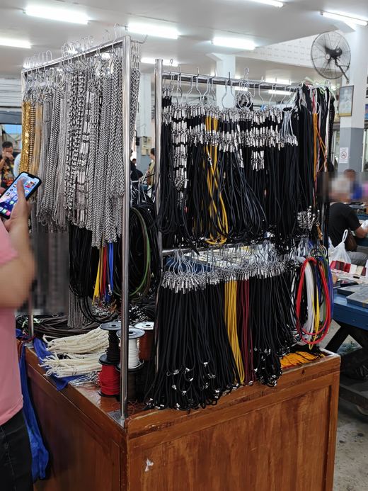 Amulet chains and cords hanging on a rack