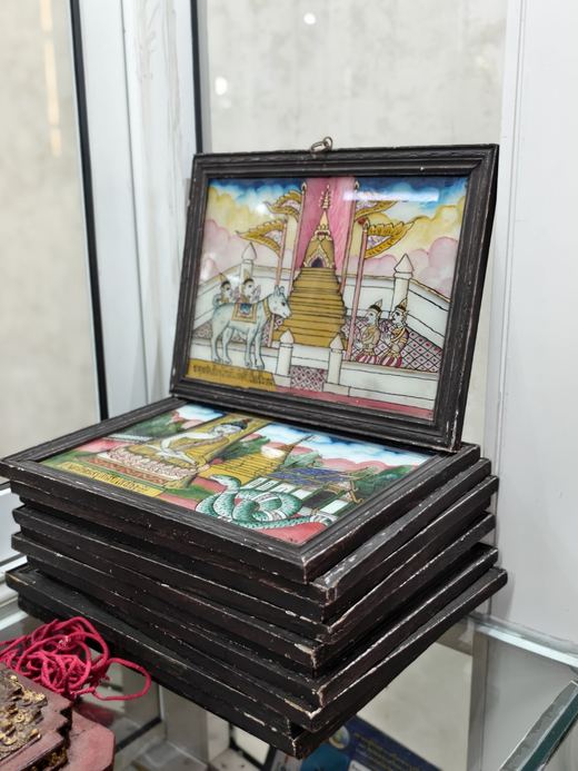 Framed reverse-glass paintings of a stupa and temple scenes