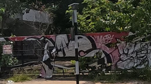 Colourful graffiti pieces on an abandoned building