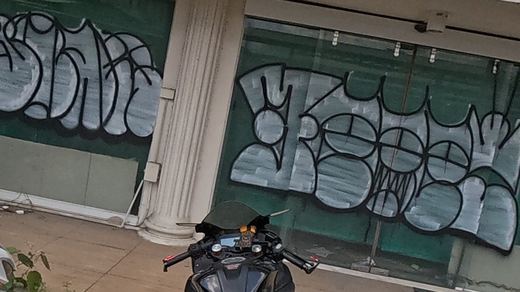 Twin bubble-letter tags on shopfront glass