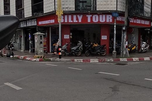 A motorbike rental and tour shop, a tattoo studio, and an organic spa salon at the far corner.