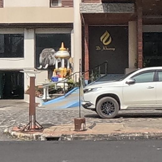 Elephant statue and shrine at a hotel entrance