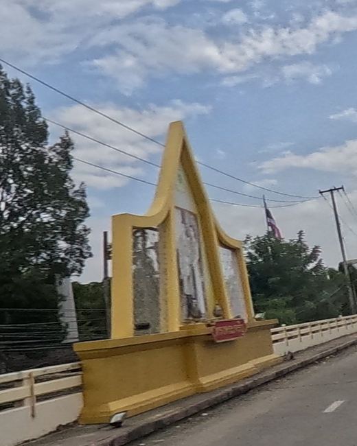 Gilded portrait shrine at the Ping River bridge