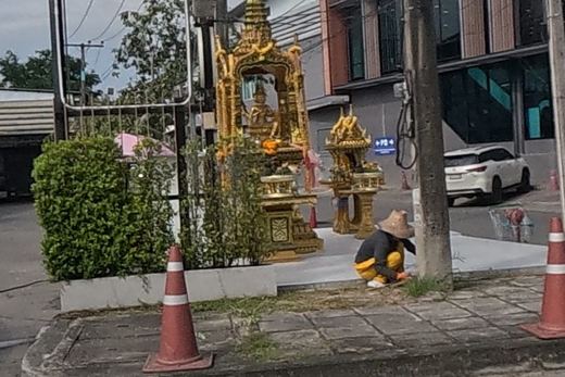 Twin gold spirit houses at the Eurasia Hotel corner