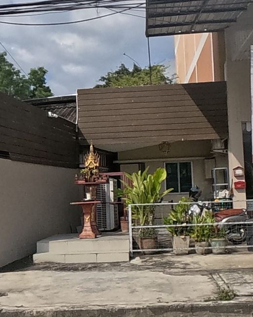 Spirit house by a furniture store