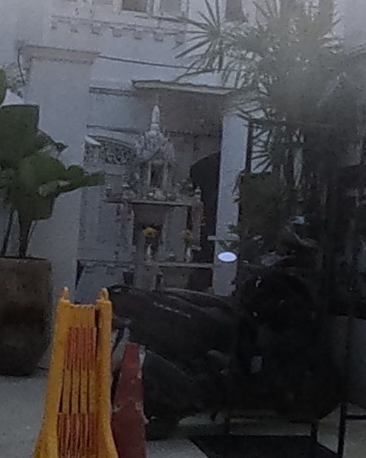 White spirit house at the Nidhra Lanna Hotel entrance