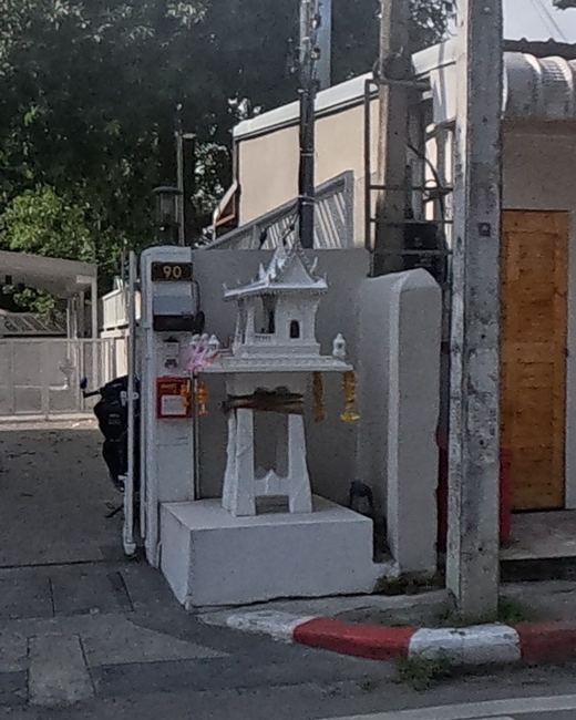 Small spirit house by a soi gate