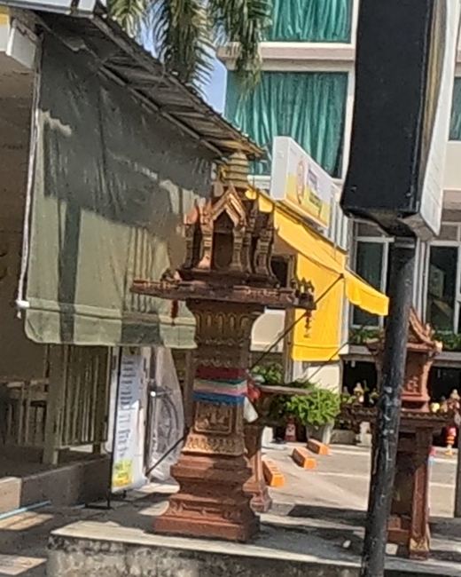 Spirit house tied with a tricolour ribbon
