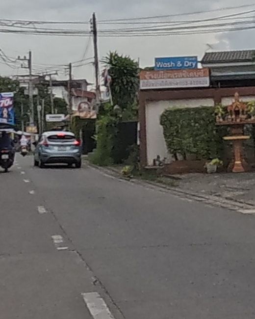 Golden spirit house on a hedged corner