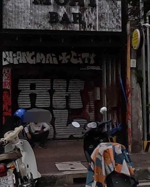 Shutter graffiti: stylized CHIANGMAI CITY tag with bubble tag below