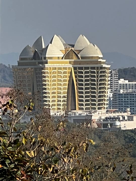 Across the Mekong from Sop Ruak: the gold-crowned tower of Kings Romans, in Laos. NaN probably left it in the picture exactly where it landed.