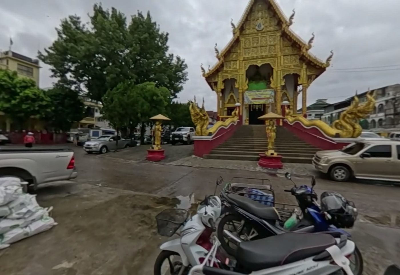 The ubosot and naga stairs seen across the temple yard