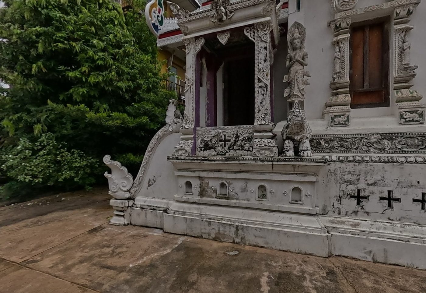 Stucco porch with praying deva and naga-tail balustrade