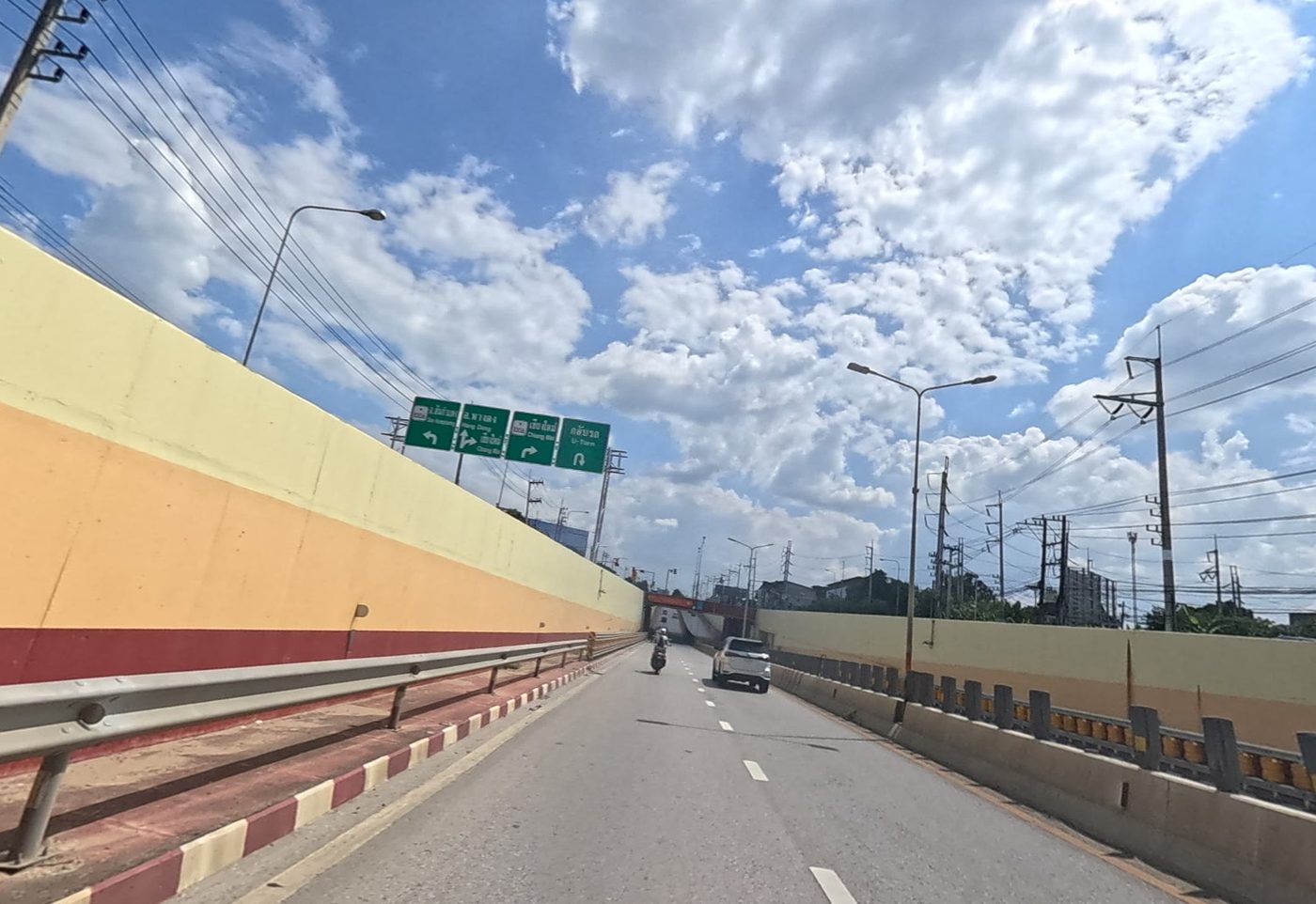 Riding into an underpass, painted barrier walls