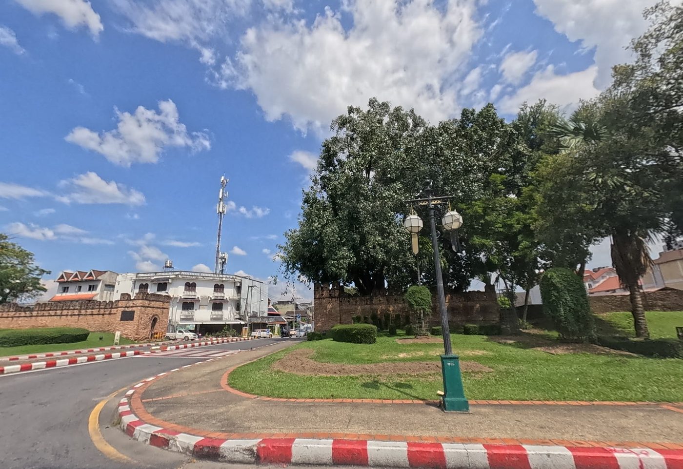 Old city wall corner bastion with a lawn and a lamp post