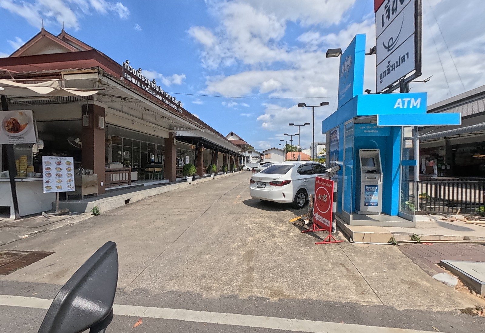 The long Lanna-roofed row of เจียง fishball noodles beside its car park, with a blue ATM kiosk and the red มาลี stand at the entrance.