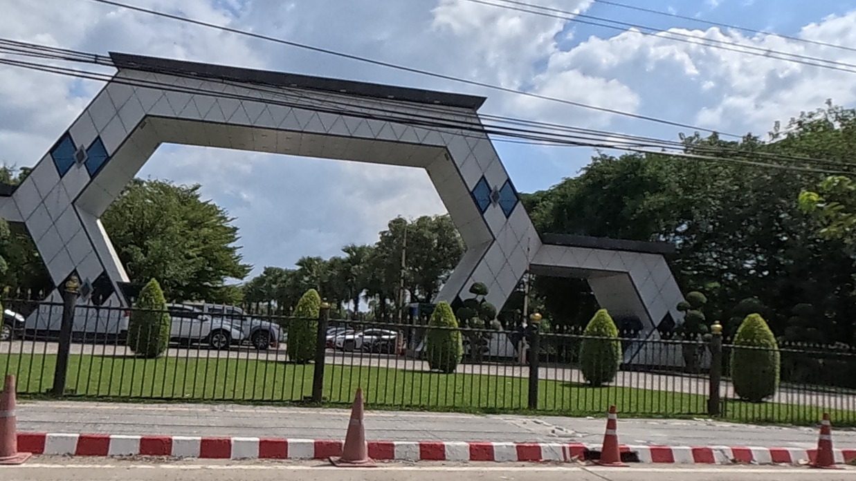 Angular black-and-white diamond-pattern gateway over a park entrance