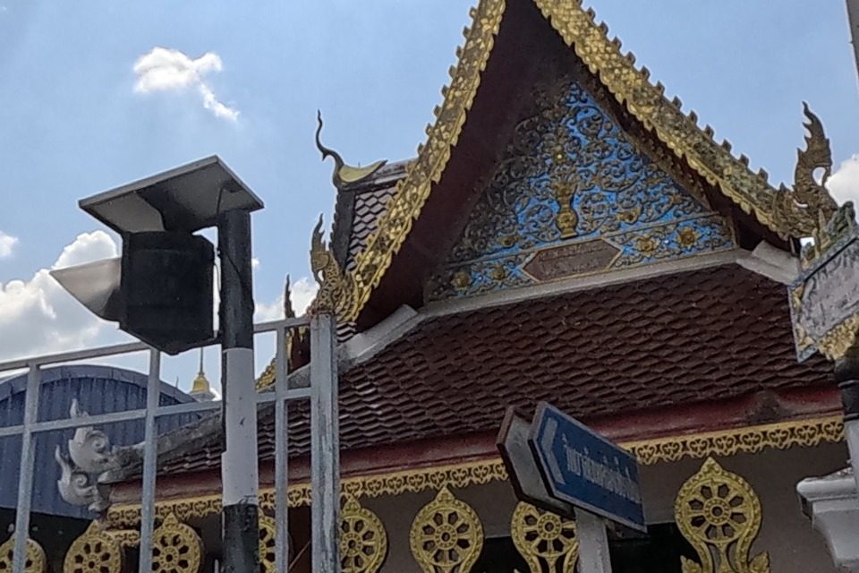 A temple gable with blue-and-gold carving