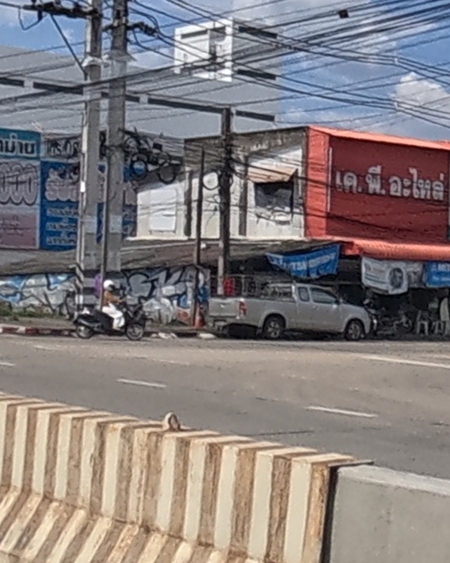 Blue-and-white bubble-letter throw-up on a shophouse wall
