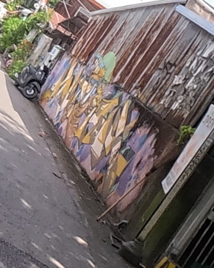 Geometric mosaic mural in a side alley