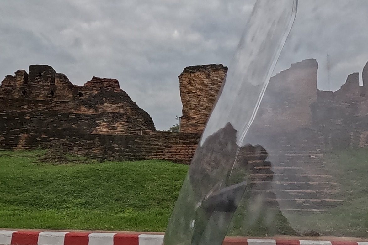The ruined brick corner bastion of Chaeng Hua Lin, an unrestored fragment of the old city wall on a grassy mound.