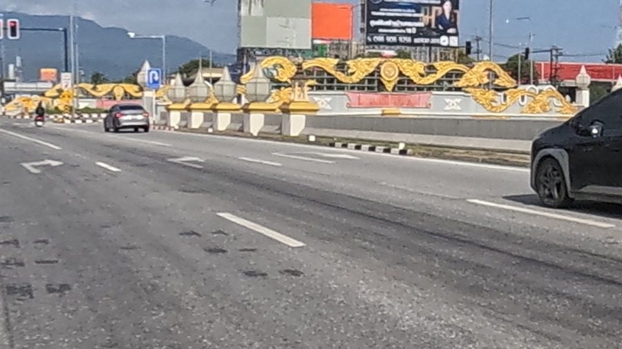 Golden naga railing on the highway median