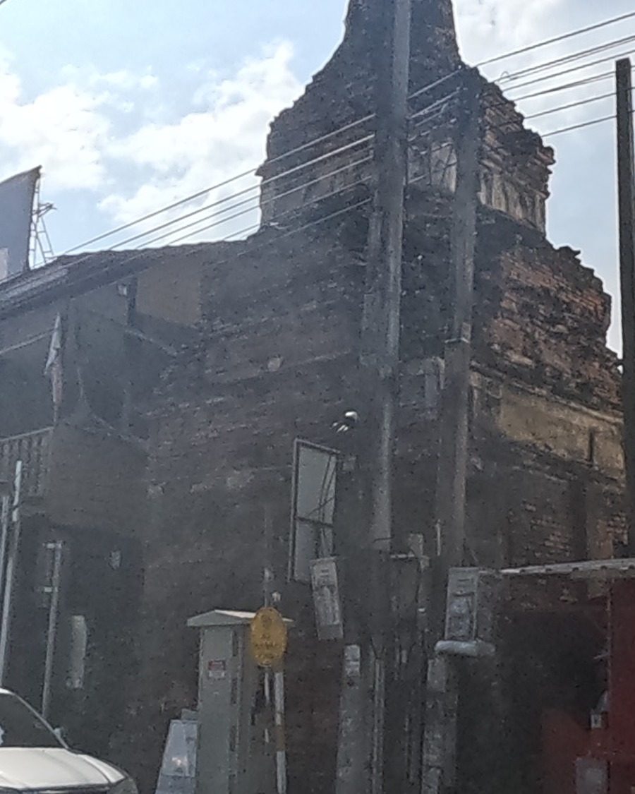 Old brick ruin beside a pharmacy