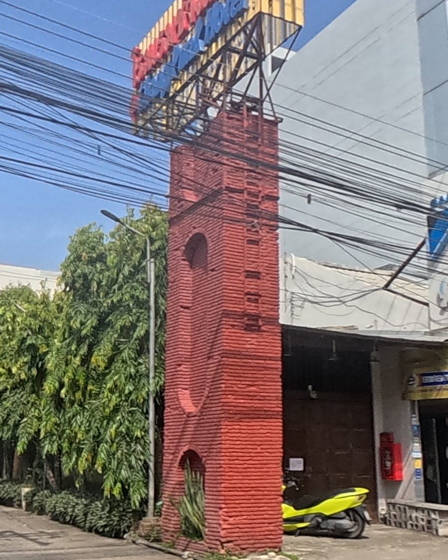 Old brick tower on the roadside