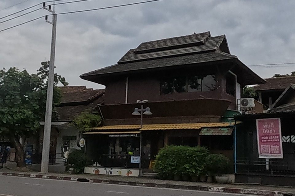 Lanna-style wooden house across the road