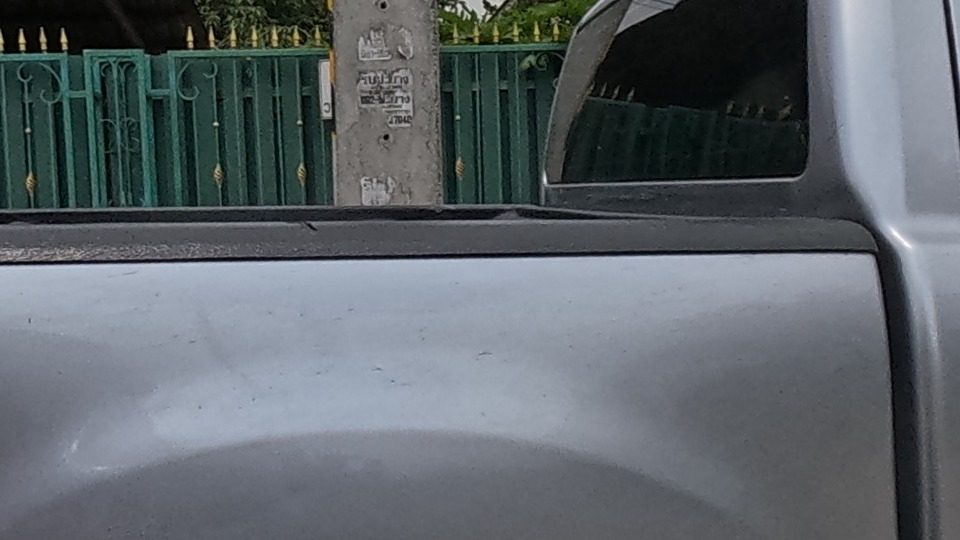 A pickup truck stretched into a limousine, parked roadside.