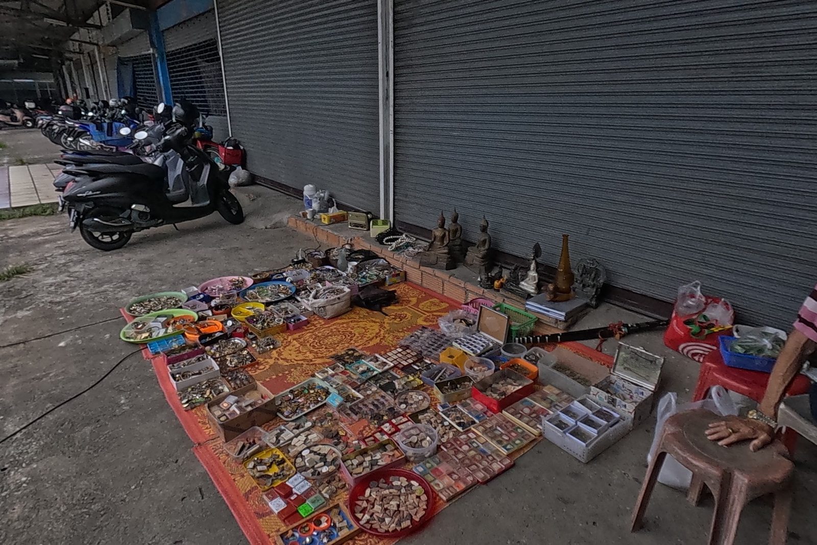 An amulet rug stall beside the market shutters