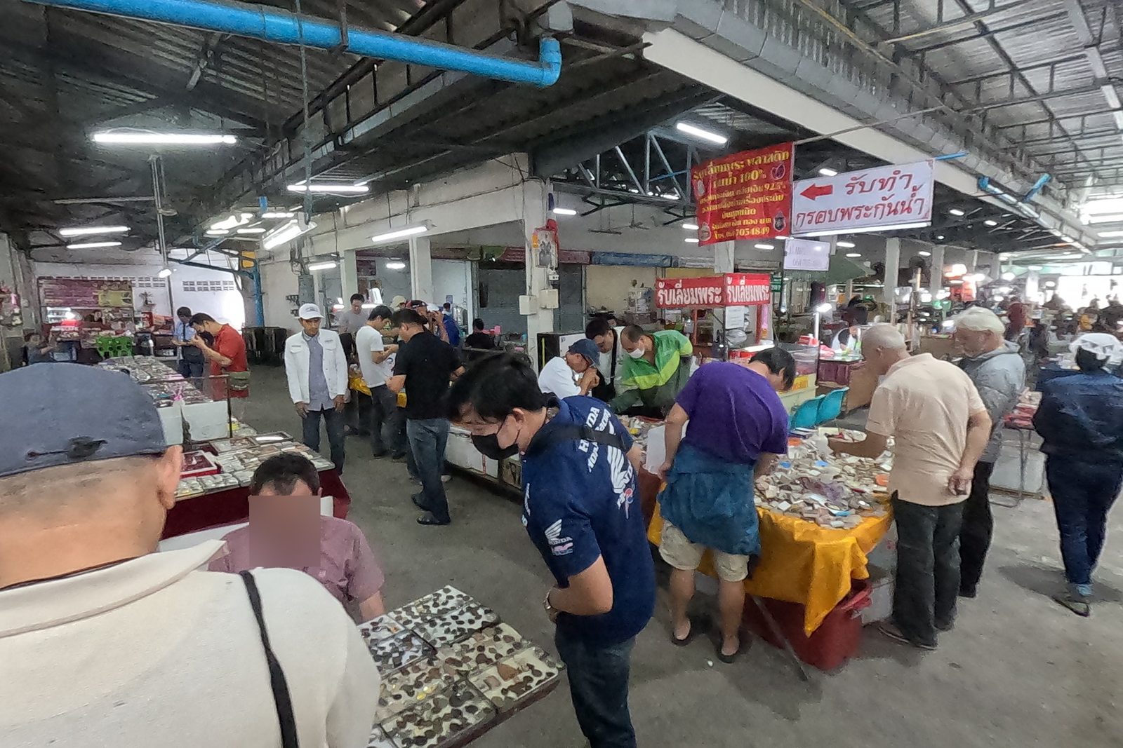 Buyers crowd the amulet tables