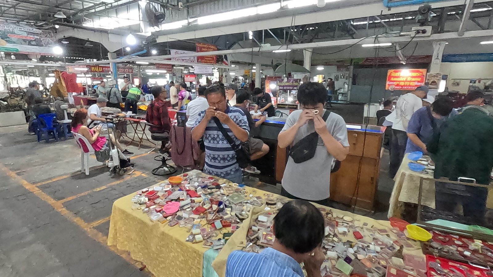 Two buyers raise their loupes