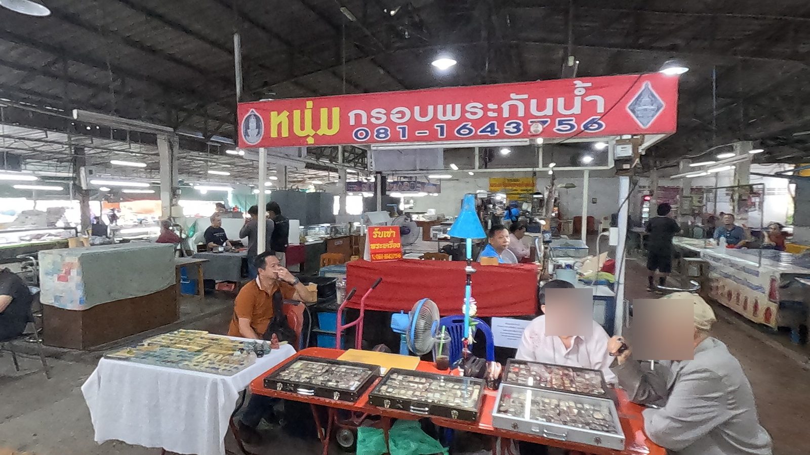 Dealers under the red casing-shop sign