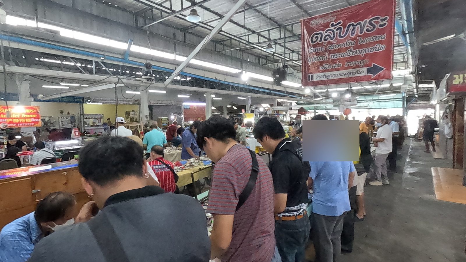 Buyers crowd the amulet tables